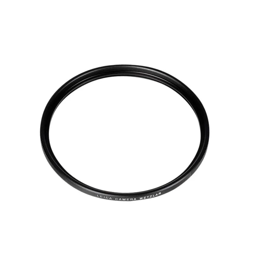 Black camera lens filter on a white background